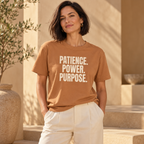 Woman wearing the PATIENCE. POWER. PURPOSE. T-shirt in Toast