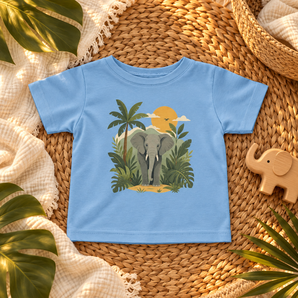 Safari Elephant Jungle Sunset infant T-shirt in Light Blue, botanical flatlay